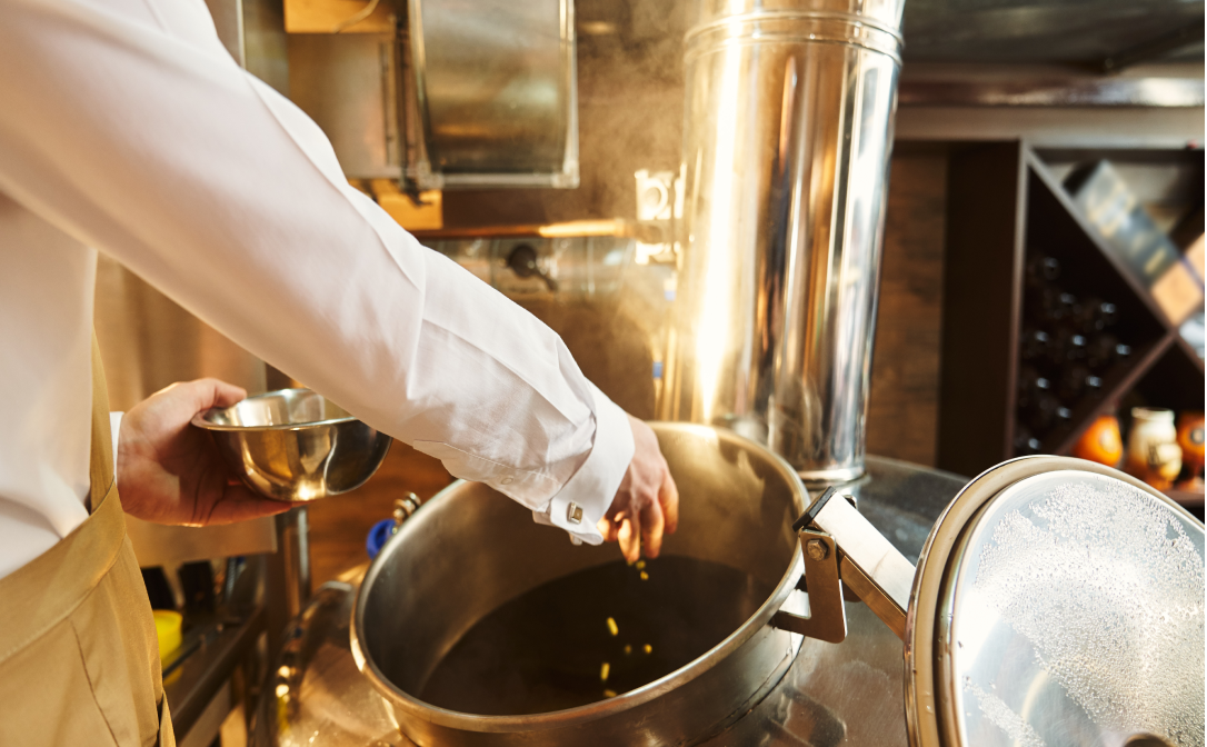 Hop pellets being added to the boil